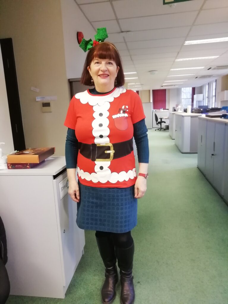 Member of Debenhams Ottaway team in a Christmas jumper and antlers