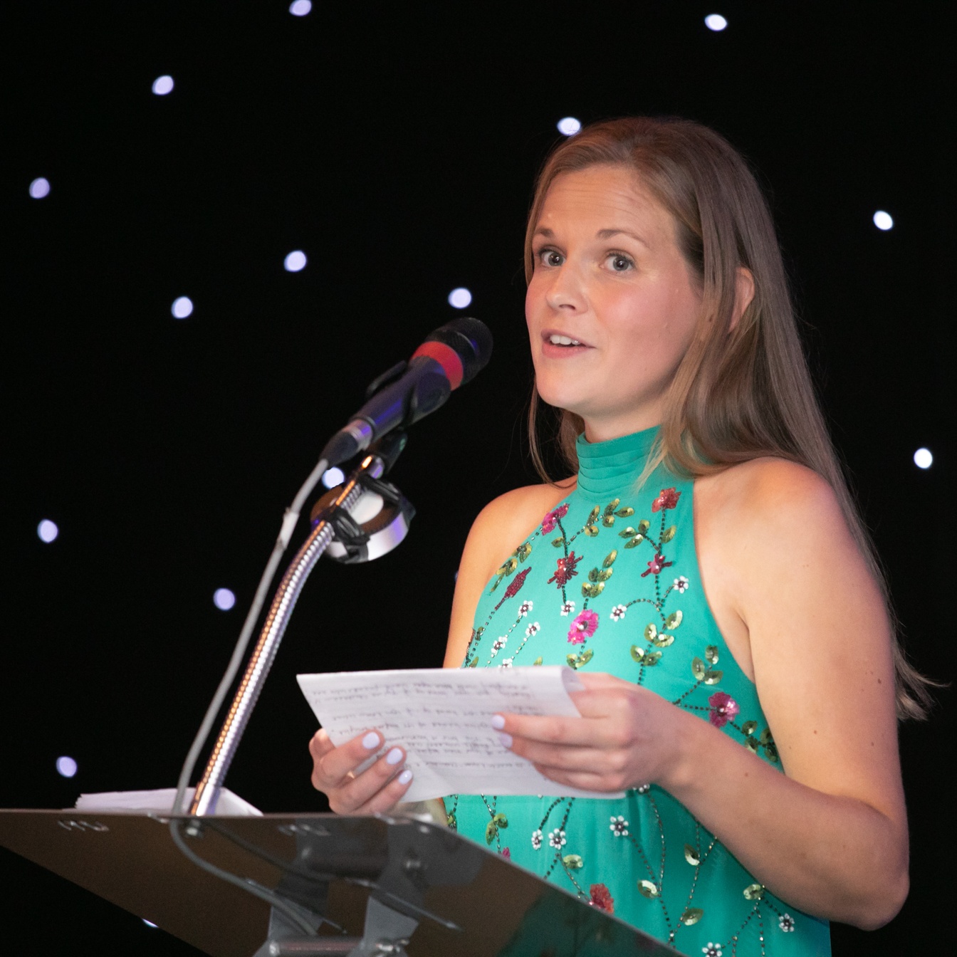 Youth Talk Fundraising Manager giving a speech about our services at the 2022 Community Business Awards