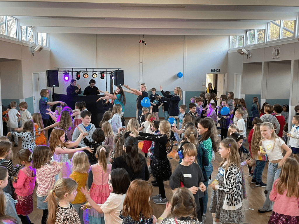 Group of young people (Brownies, Beaver Scouts, Club Scouts, and Rainbows) at a disco fundraiser held my the St Albans South District Rangers.