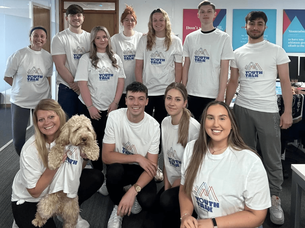 Amber Mountain Marketing team smiling in Youth Talk t-shirts during their June fundraising challenge.